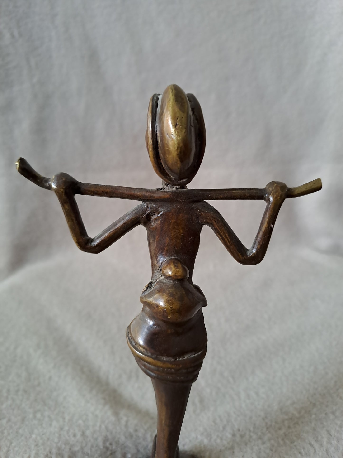 Statue représentant une femme africaine portant un enfant dans le dos.