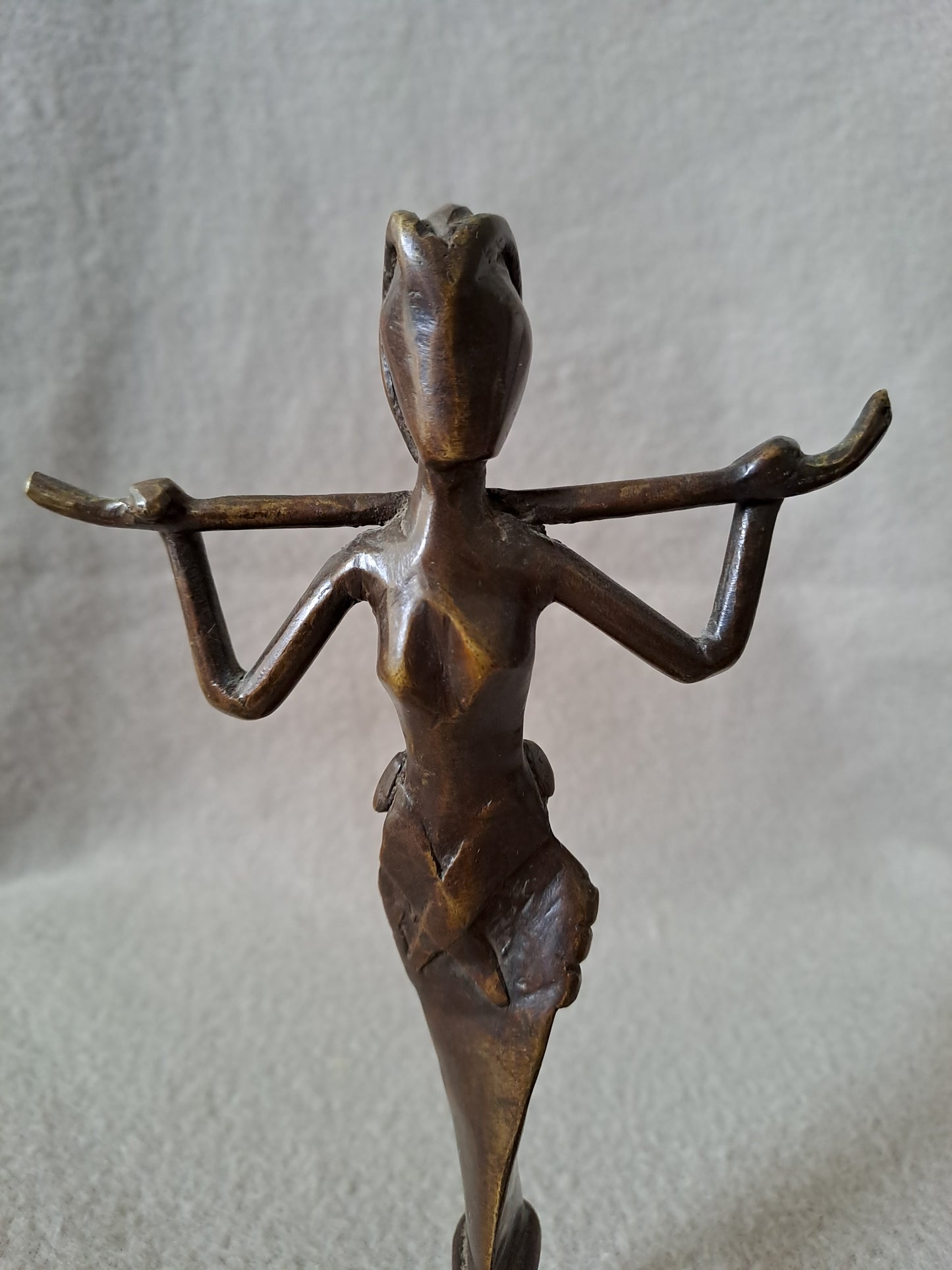 Statue représentant une femme africaine portant un enfant dans le dos.